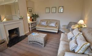 a living room with a couch and a fireplace at Kates Cottages Bracken Lodge in Spott +103 photos