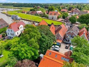 an aerial view of a town with houses and a river at Villa Aurum in Greetsiel