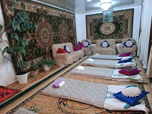 a living room with two beds and a couch at Anarhan Guesthouse Horse riding to Song-Kol and Kilemche in Kyzart