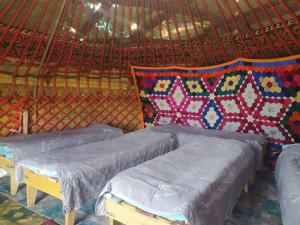 a room with three beds in a yurt at Yurt camp Marat Son-Kul in Song-Kul