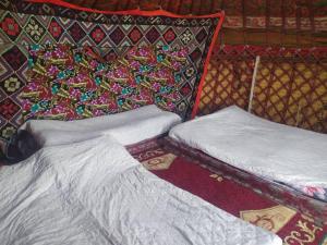 two beds sitting next to each other in a room at Yurt camp Marat Son-Kul in Song-Kul