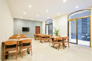 a conference room with tables and chairs and windows at Hotel Condal in Barcelona