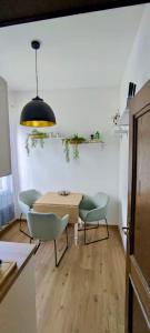 a dining room with a table and two chairs at Direkt am Wanderweg, Ferienwohnung im Allgäu nahe Oberstaufen in Oberstaufen