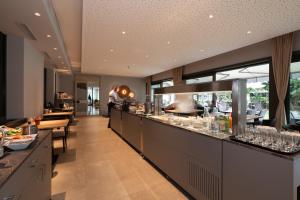 a restaurant with a bar with glasses on the counter at Hotel Unione in Bellinzona