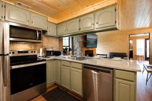 a kitchen with white cabinets and stainless steel appliances at Mountain Views at Dolly's Castle Unit 3 in Sevierville