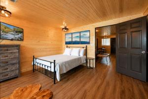 a bedroom with a bed in a wooden room at Mountain Views at Dolly's Castle Unit 3 in Sevierville +12 photos