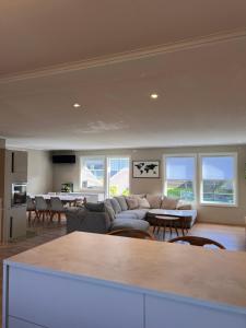 a living room with a couch and a table at Flott hus på Tasta in Stavanger