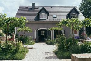 a house with a garden in front of it at Flowland Tarczyn in Tarczyn