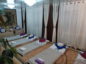 a living room with four pillows on the floor at Anarhan Guesthouse Horse riding to Song-Kol and Kilemche in Kyzart