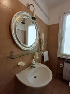 a bathroom with a sink and a mirror at Casa Vacanze Boario in Boario Terme +31 photos
