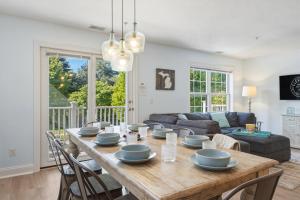 a living room with a wooden table with chairs at Downtown Oasis by the Bay in Traverse City