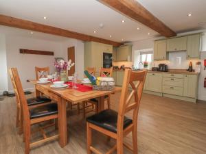 a kitchen and dining room with a wooden table and chairs at Miller's Wheel in Harrogate