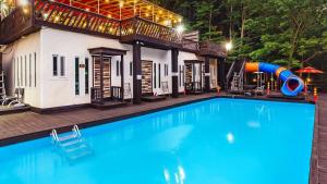 a swimming pool with a slide in front of a house at Ulsan Lime House in Ulsan