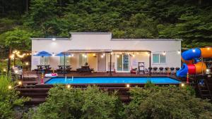 a house with a swimming pool in front of it at Ulsan Lime House in Ulsan