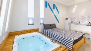 a bathroom with a bath tub in the middle of a room at Ulsan Lime House in Ulsan +30 photos