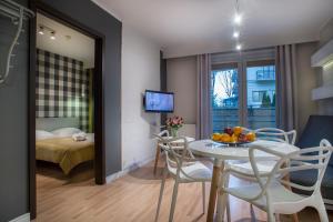 a room with a table and chairs and a bedroom at Apartamenty Nautilus in Świnoujście +152 photos