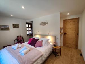 a bedroom with a large bed with two pillows at O Clarée in Val-des-Prés