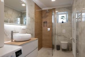 a bathroom with a sink and a shower at Villa Bella in Čitluk +57 photos