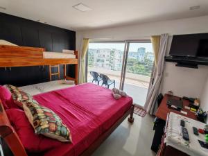 a bedroom with a bunk bed and a large window at fontaine bleau piso 4F in Atacames +19 photos