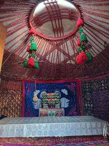 a room with a bed in a yurt at Anarhan Guesthouse Horse riding to Song-Kol and Kilemche in Kyzart +25 photos