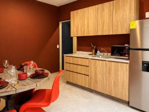 a kitchen with a table and a refrigerator at Casa DUALIA in San Miguel de Allende