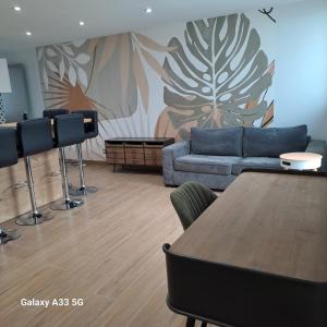 a living room with a couch and a table at LE 37 croix in Gennes