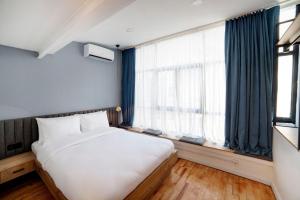 a bedroom with a bed and a large window at Medusa Historic Luxury Hotel Galata in Istanbul