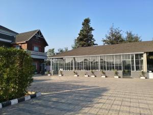 a large building with glass windows in a courtyard at Crystal Garden in Lalru