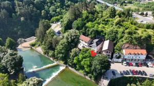 an aerial view of a house next to a river at Apartmani Waterfall / Vodopad in Jajce