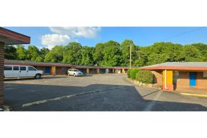 a parking lot in front of a motel at Lion Inn Albemarle By Hotel O Near US 52 in Albemarle +33 photos