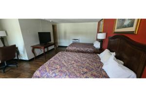 a hotel room with two beds and a television at Lion Inn Albemarle By Hotel O Near US 52 in Albemarle