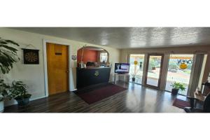 a living room with a kitchen and a lobby at Lion Inn Albemarle By Hotel O Near US 52 in Albemarle