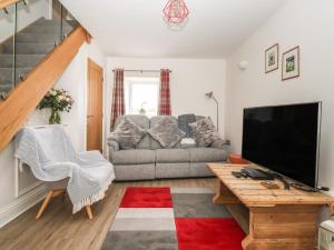 a living room with a couch and a television at Shepherd's Crook in Harrogate
