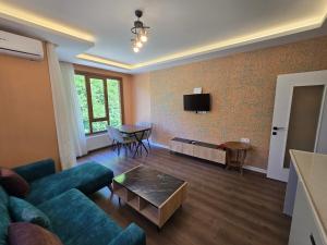 a living room with a couch and a table at ESLA Suites in Çamlıhemşin