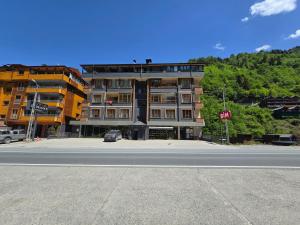 a building on the side of a street with a stop sign at ESLA Suites in Çamlıhemşin