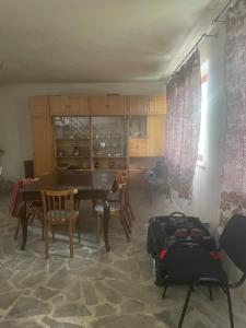 a living room with a table and chairs and a dining room at Lake View Sioni in Sioni