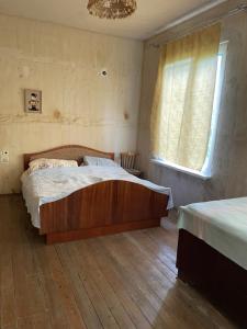 a bedroom with a large bed and a window at Lake View Sioni in Sioni