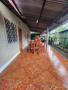 a dining room with a table and chairs on a tile floor at Hostal Bullshark in Cuatro Esquinas +76 photos