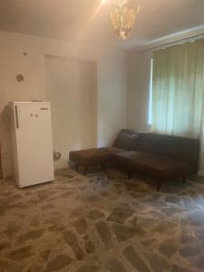 a living room with a couch and a refrigerator at Lake View Sioni in Sioni