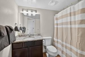 a bathroom with a sink and a toilet and a shower at Moab RedCliff Condos in Moab