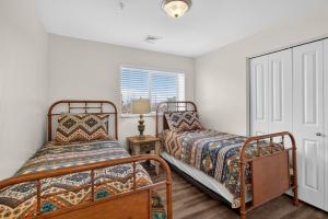 a bedroom with two beds and a window at Moab RedCliff Condos in Moab