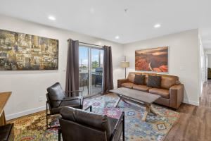 a living room with a couch and a table and chairs at Moab RedCliff Condos in Moab