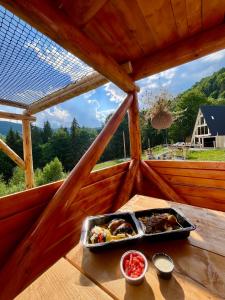 a tray of food on a table in a cabin at Cabana KayLuna in Mătişeşti