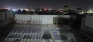 a view from the top of a building at night at kanakdhara aashraya in Vrindāvan