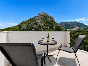 a table and chairs on a balcony with wine glasses at WEST GATE free parking & wi-fi in Sutomore