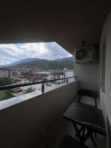 a balcony with a chair and a view of a city at Hotel Boheme in Peje