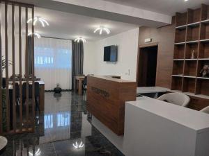 a living room with a kitchen and a dining room at Hotel Boheme in Peje