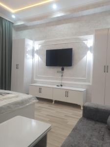a living room with a flat screen tv on a wall at Terras Astara in Astara