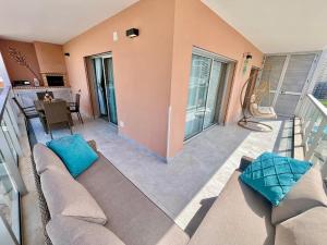a living room with a couch and a balcony at GM Premium Portimão in Portimão