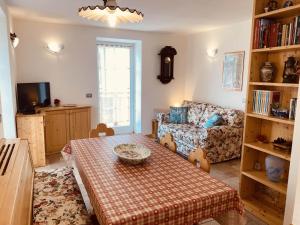 a living room with a table and a couch at My sweet home in the Dolomites - Appartamento LatteMiele in Predazzo